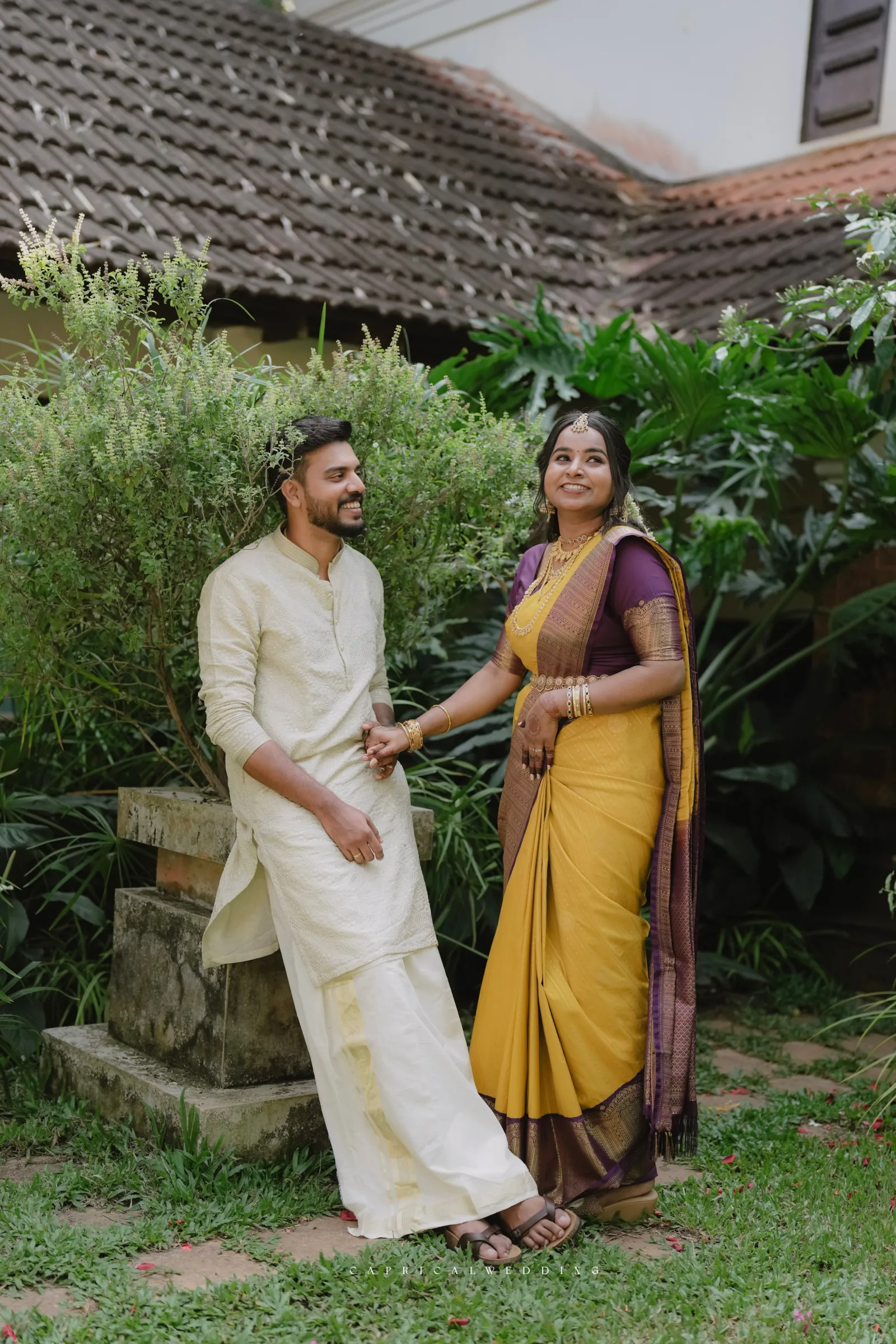 A couple walking together in a garden courtyard