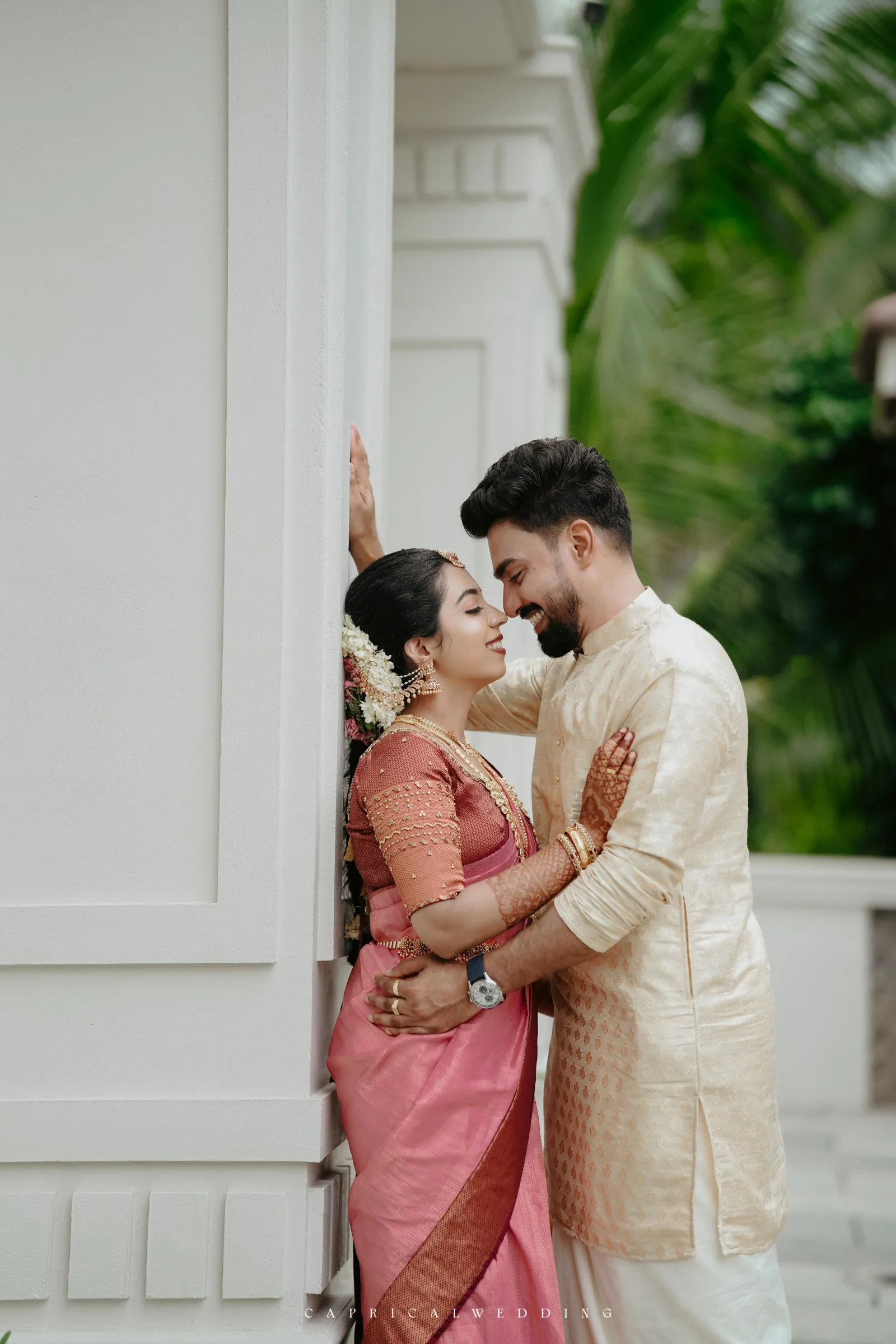 A couple sharing a quiet moment beside white columns